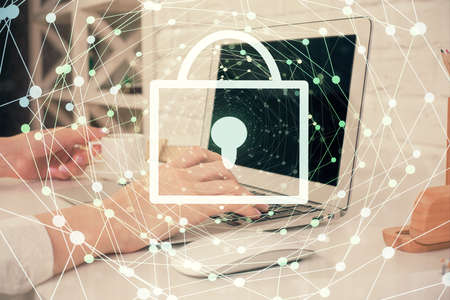 Double exposure of woman hands working on computer and lock hologram drawing. Security concept.