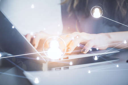 Double exposure of woman hands typing on computer and social network theme hologram drawing. People media concept.の写真素材