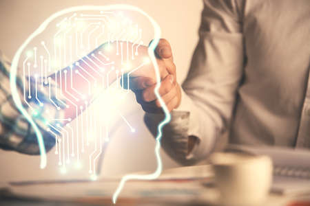 Double exposure of brain hologram and handshake of two men. Partnership in IT industry concept.