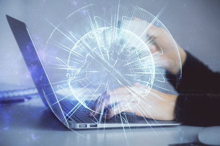 Multi exposure of woman hands typing on computer and business theme hologram drawing. Success concept.の写真素材