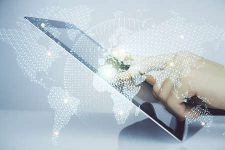 Double exposure of mans hands holding and using a phone and international business theme drawing.