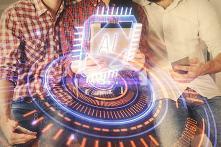 Double exposure of data theme hologram drawing and man and woman working together holding and using a mobile device.の写真素材