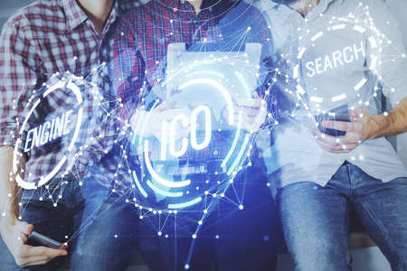 Double exposure of crypto theme drawing and man and woman working together holding and using a mobile device. Blockchain concept.の写真素材