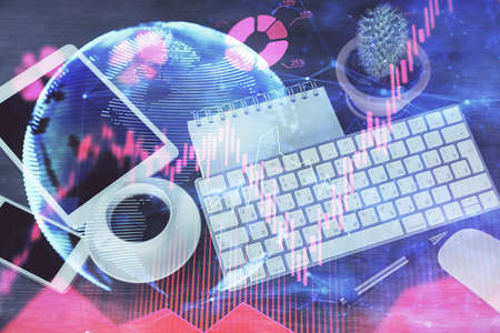 Double exposure of business theme hologram over desktop with phone. Top view. Mobile international trade connection concept.の写真素材