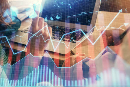 Double exposure of man and woman working together and forex chart hologram. Business concept....