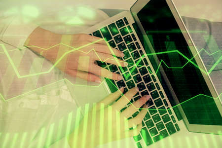 Double exposure of woman hands working on computer and forex chart hologram drawing. Top View....