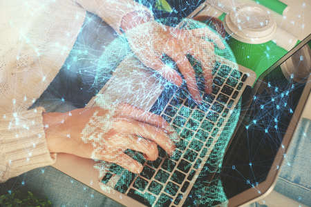 Double exposure of woman hands working on computer and brain hologram drawing. Ai concept.