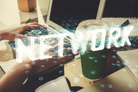 Double exposure of woman hands working on computer and data theme hologram drawing. Tech concept.の写真素材