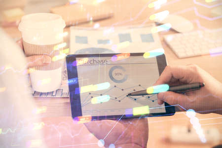 Multi exposure of mans hands holding and using a digital device and data theme drawing. Innovation...