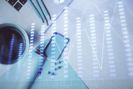 Double exposure of forex graph drawing over desktop background with computer. Concept of financial...