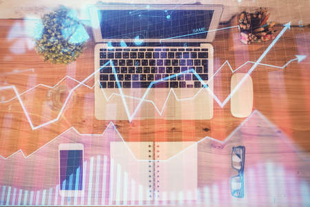 Multi exposure of financial chart drawing over table background with computer. Concept of research....