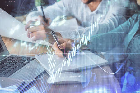 Double exposure of forex chart drawing over people taking notes background. Concept of financial...