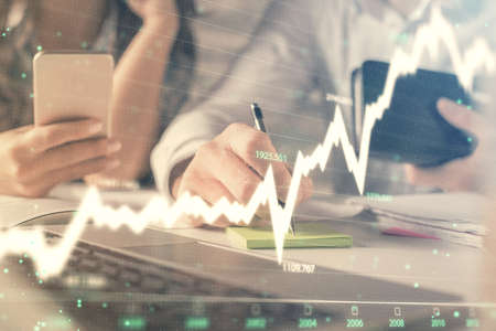 Double exposure of man and woman working together and financial graph hologram. Business concept....