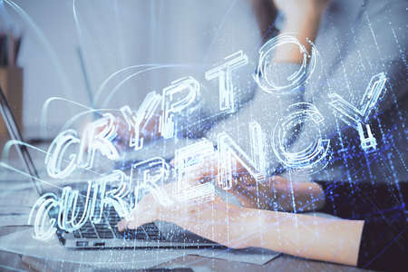 Double exposure of woman hands typing on computer and crypto market theme hologram drawing. Blockchain concept.の写真素材