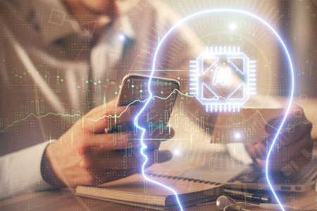 Double exposure of mans hand holding and using a digital device and brain hologram drawing. Data...