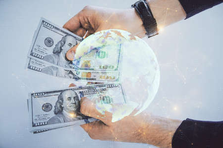 Multi exposure of social network theme drawing hologram and USA dollars bills and man hands.の写真素材
