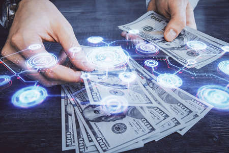 Multi exposure of social network theme drawing hologram and USA dollars bills and man hands.の写真素材