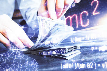 Multi exposure of Formulas drawing hologram and USA dollars bills and man hands. Education