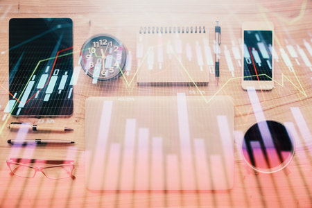 Double exposure of forex graph hologram over desktop with phone. Top view. Mobile trade platform concept.の写真素材