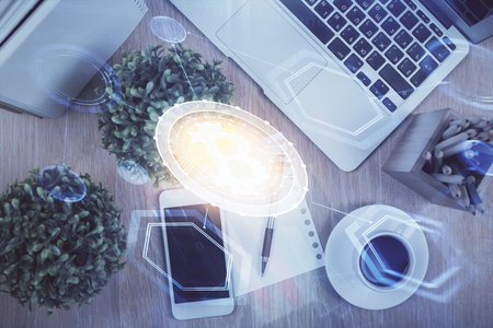 Double exposure of blockchain theme hologram over table with phone. Top view. Crypto technology concept.の写真素材