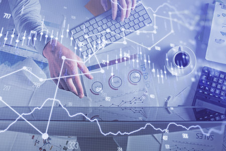 Multi exposure of mans hands typing over computer keyboard and forex graph hologram drawing. Top...