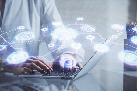 Double exposure of woman hands typing on computer and social network theme hologram drawing. People...