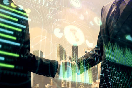 Double exposure of data theme hologram and handshake of two men. Partnership in IT industry concept.