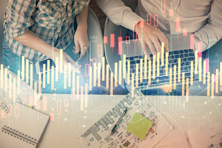 Multi exposure of man and woman working together and forex graph hologram drawing. Financial...