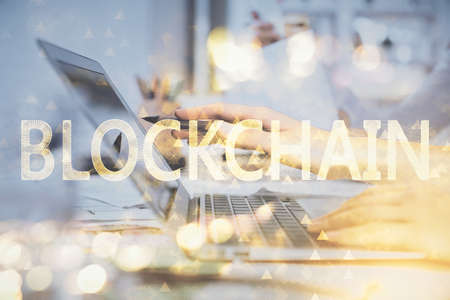 Double exposure of woman hands typing on computer and crypto market theme hologram drawing....