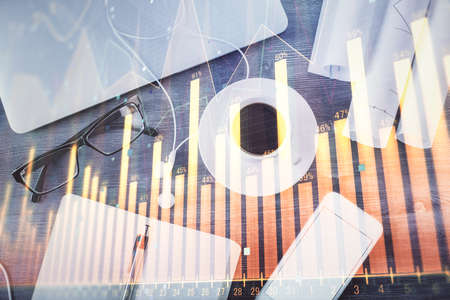 Multi exposure of forex graph drawing over desktop background with computer. Concept of financial...