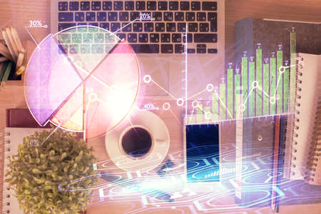 Double exposure of financial graph hologram over desktop with phone. Top view. Mobile trade platform concept.の写真素材