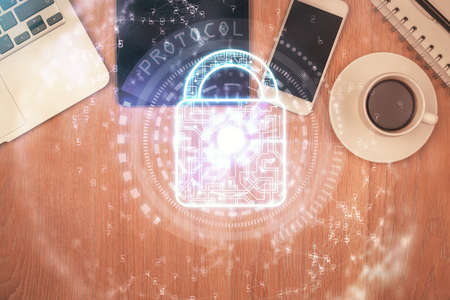 Double exposure of lock drawing over desktop. Top view. Security concept.