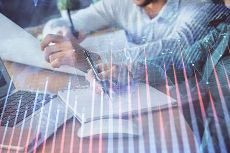 Double exposure of forex chart drawing over people taking notes background. Concept of financial...