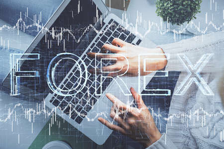 Double exposure of woman hands working on computer and forex chart hologram drawing. Top View....