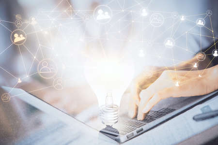 Double exposure of woman hands typing on computer and social network theme hologram drawing. People...