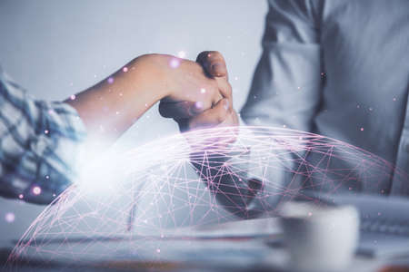 Double exposure of social network theme hologram and handshake of two men.の写真素材