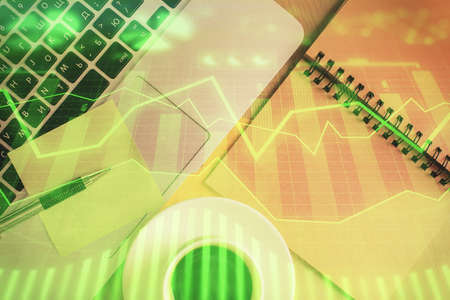 Stock market graph and top view computer on the table background. Double exposure. Concept of...