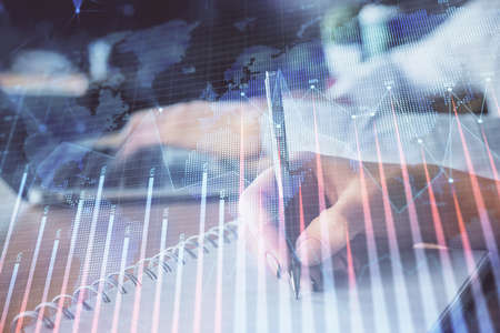 Double exposure of forex chart drawing over people taking notes background. Concept of financial...