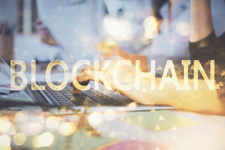 Double exposure of woman hands typing on computer and crypto market theme hologram drawing. Blockchain concept.の写真素材