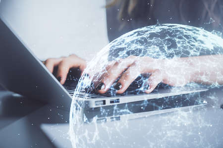 Double exposure of woman hands typing on computer and social network theme hologram drawing. People...