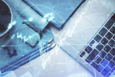 Double exposure of forex graph drawing over desktop background with computer. Concept of financial...