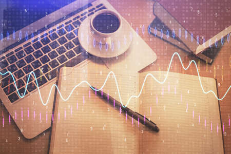 Stock market graph and top view computer on the table background. Multi exposure. Concept of...
