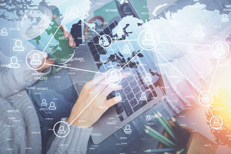Double exposure of woman hands typing on computer and social network theme hologram drawing. People...