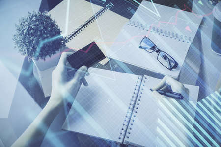 Multi exposure of woman on-line shopping holding a credit card and financial graph drawing. Stock market E-commerce concept.の写真素材