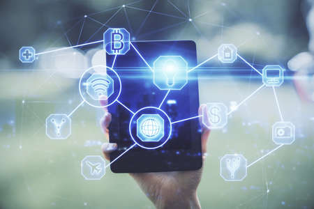 Double exposure of social network sketch hologram and woman holding and using a mobile device.