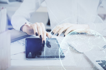 Double exposure of social network sketch hologram and woman holding and using a mobile device.
