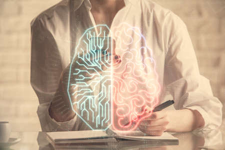 Double exposure of brain sketch hologram and woman holding and using a mobile device.の写真素材