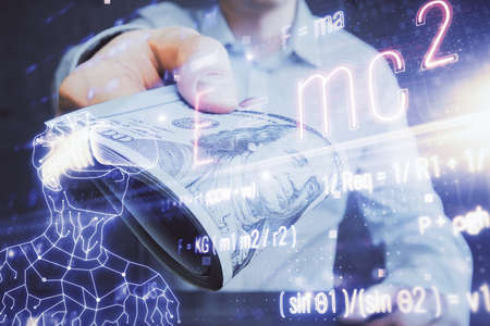 Multi exposure of Formulas drawing hologram and USA dollars bills and man hands. Educationの写真素材