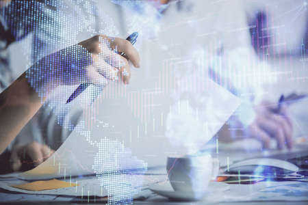 Double exposure of forex graph drawing over people taking notes background. Concept of financial...