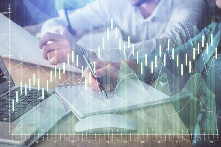 Double exposure of forex chart drawing over people taking notes background. Concept of financial...